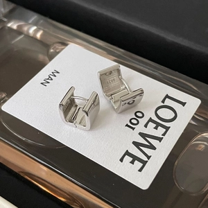 Macro shot of square S925 sterling silver hoop earrings with engraved hallmark