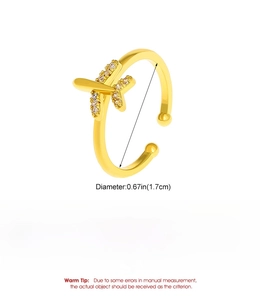 Detail of adjustable gold airplane ring with crystal wings showing diameter and weight info