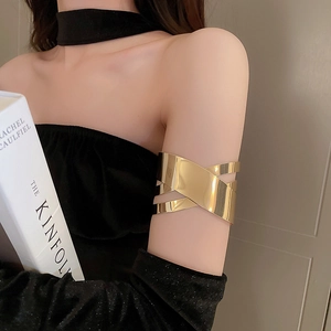 Dettaglio del bracciale da braccio geometrico dorato con finitura lucida a specchio