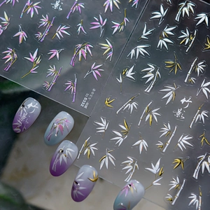 Macro detail of pink and white metallic bamboo leaf nail art stickers with 3D texture