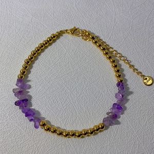 Macro view of 18k gold plated stainless steel beads and purple amethyst stones bracelet