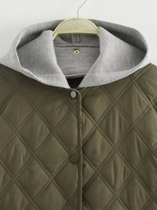 Detail der armygrünen Steppjacke mit hellgrauer Kapuze und Rautensteppmuster-Verarbeitung