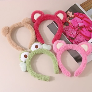 Flat lay of colorful plush animal headbands including bear and frog styles for women