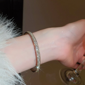 Detailed close-up of a luxury gold-plated bangle with sparkling pavé cubic zirconia