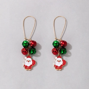 Detail shot of Santa Claus earrings with festive red and green bells on golden hooks