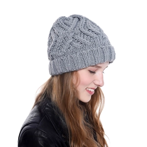 Close-up of light grey chunky knit beanie with textured diamond pattern for winter warmth