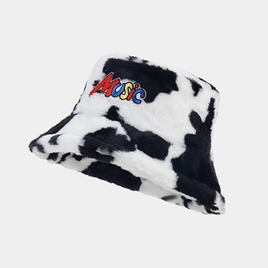 Close-up of soft cow print bucket hat with embroidered colorful Music lettering detail