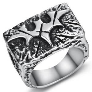 Macro detail of gothic signet ring featuring vintage silver cross relief and oxidized texture