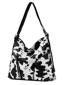 Large cow print tote bag in PU leather with adjustable straps and side zipper details