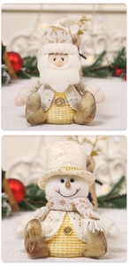 Detailed view of knitted fabric and golden sequins on Santa and Snowman holiday plush