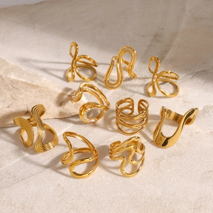 Detailed view of chunky gold rings with irregular textures on stone background