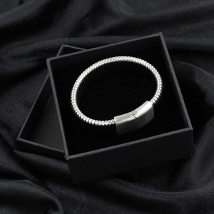 Macro detail of silver titanium steel bracelet with jigsaw interlocking clasp design