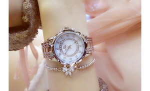 Silver ladies watch with rhinestone dial and matching bow bracelet on female wrist