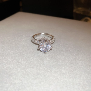 Macro shot of silver butterfly zircon ring with sparkling round brilliant-cut gemstone