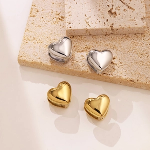 Elegant 18k gold and silver stainless steel heart earrings on a natural stone base