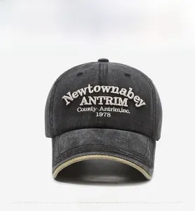 Detailed close-up of vintage grey washed cotton baseball cap with 3D embroidery textures