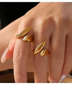 Close-up of 18k gold plated stainless steel irregular rings worn on a model's hand