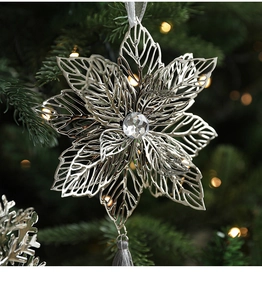 Detail of silver snowflake metal ornament with faceted crystal and silk tassel