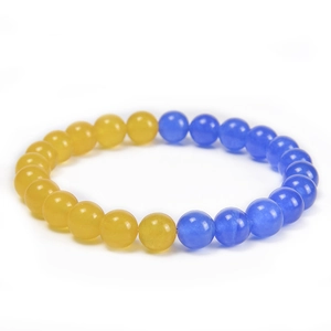 Detail of blue and yellow natural stone beaded bracelet with polished round crystal beads