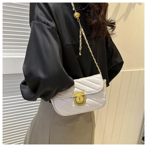White quilted crossbody bag with gold chain strap and adjustable ball on a model