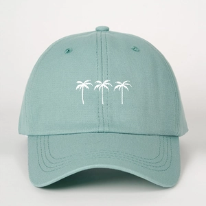 Detail of mint green cotton baseball cap featuring white palm tree embroidery