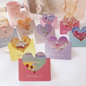 Detail of assorted heart-shaped cutout cards with colorful artistic patterns and envelopes