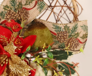 Close-up of Christmas heart wreath with red poinsettia and gold glitter leaves