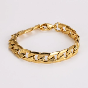 Detailed view of golden Cuban link chain with textured surface and lobster clasp