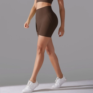 Macro side view of high-waisted seamless chocolate brown yoga shorts on female model