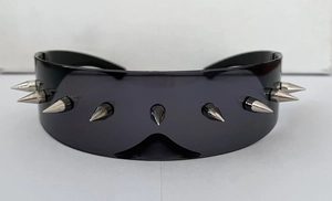 Detail view of silver conical spikes on futuristic punk oversized wraparound sunglasses