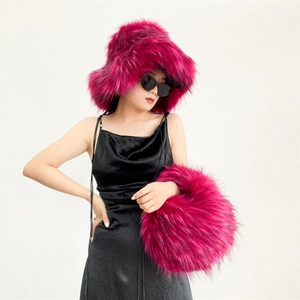 Detail of fluffy faux raccoon fur handbag and matching oversized hat in hot pink