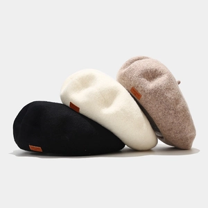 Classic wool beret stack in black, beige and oatmeal with leather tag detail