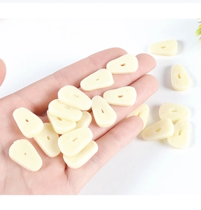 Macro shot of realistic miniature PVC garlic slices for dollhouse DIY food scenes