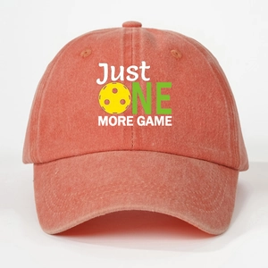 Detailed macro view of embroidered Just One More Game slogan on a vintage washed baseball cap