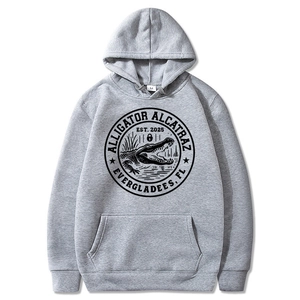 Light gray hoodie with round black alligator emblem and Alcatraz graphic on white background
