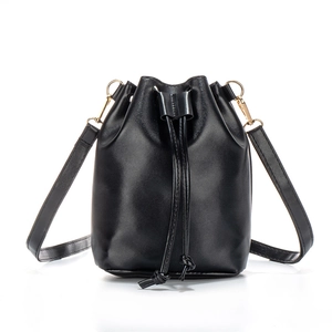 Classic black drawstring bucket bag in matte leather with gold-tone hardware on white background