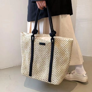 Large capacity beige woven straw tote bag with black rope straps for summer vacations