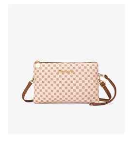 Detailed view of pink crossbody bag with geometric pattern and gold zipper closure