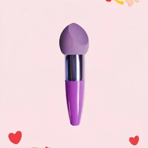 Detail of purple makeup sponge brush with slanted head and gradient handle on pink background