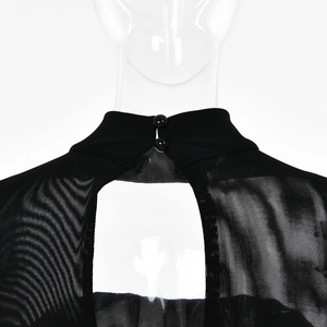 Detail of sheer black mesh dress featuring a high neck and elegant back cutout with buttons