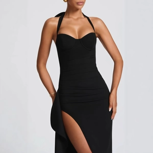 Detail of high side slit and pleated waist on a backless black halter evening dress