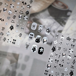 Christmas nail stickers with black and white dogs, snowmen and silver bow designs