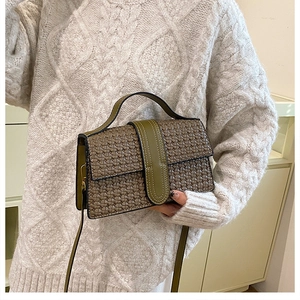 Detail of army green crossbody bag featuring vintage woven texture and magnetic flap closure