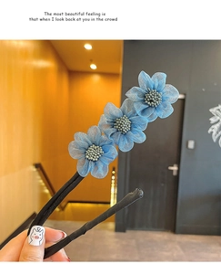Detail of blue mesh flower hair bun maker tool with beaded stamens for elegant styling