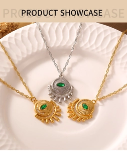 Macro shot of French retro eye pendant necklaces in gold and silver with green zircons