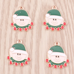 Detail of Christmas elf enamel pendants in red and green for DIY jewelry making