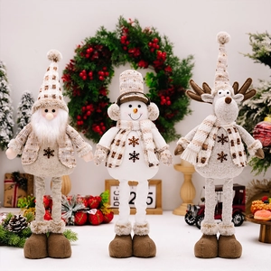 Detailed view of plush Christmas doll set with Santa, snowman and reindeer on a table