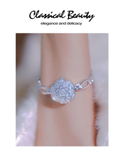 Macro shot of an elegant silver floral bracelet with sparkling crystals on a soft background