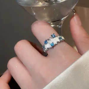 Irregular silver zircon geometric ring with textured finish on female model's finger
