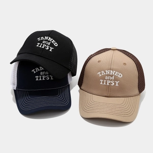 Three assorted mesh trucker hats with TANNED and TIPSY embroidery in various colors